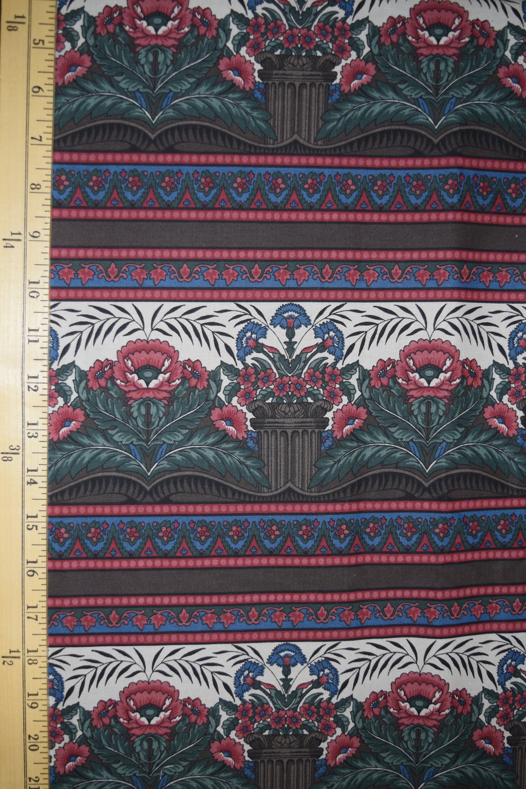 Jinny Beyer. Art deco botanical design in a border print. Shades of red, blue, and brown. 